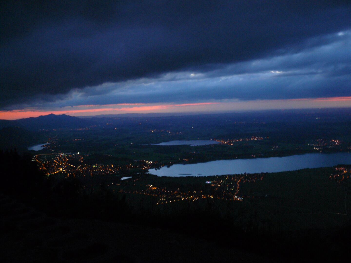 The Forggensee and city of Füssen in the evening, as seen from Tegelberghaus.