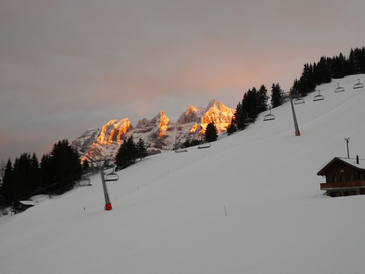 The view from our chalet's living room: Les Dents du Midi in the evening sun. In the front is the lift up to our local mountain. 