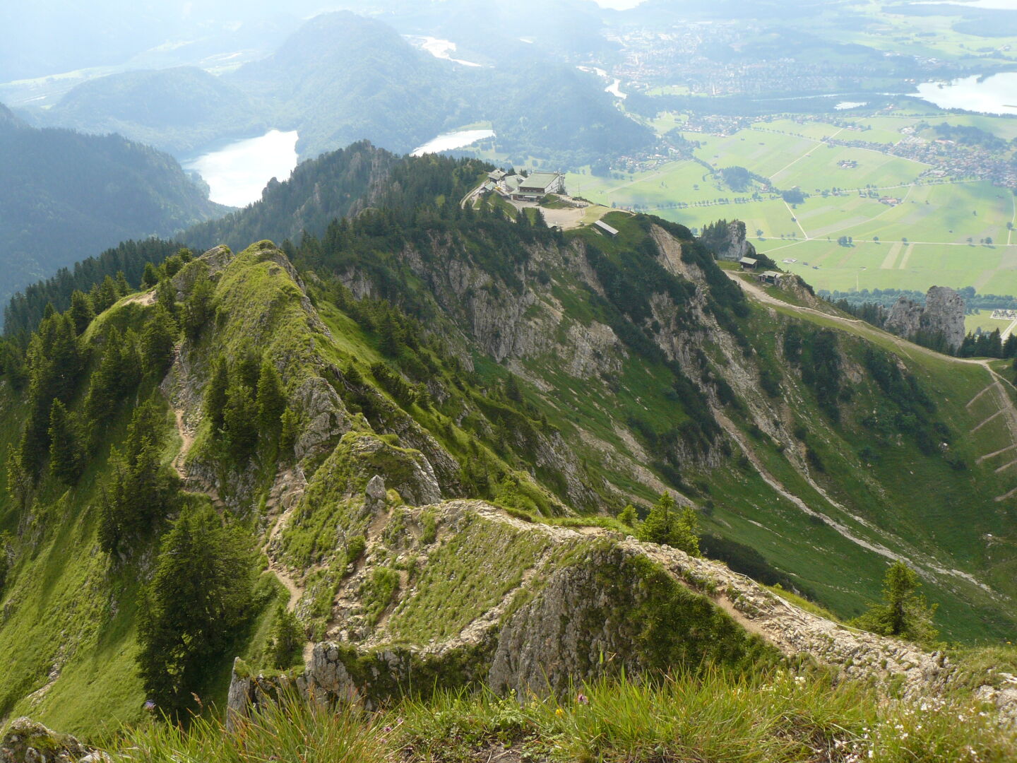 On the peak of the Branderschrofen (1 879 m). In the back, you can see the Tegelberghaus, a mountain hut where I spent the night. And the lakes in the distance on the left are the Alpsee and Schwanensee, between which lies the Castle Hohenschwangau (not visible).