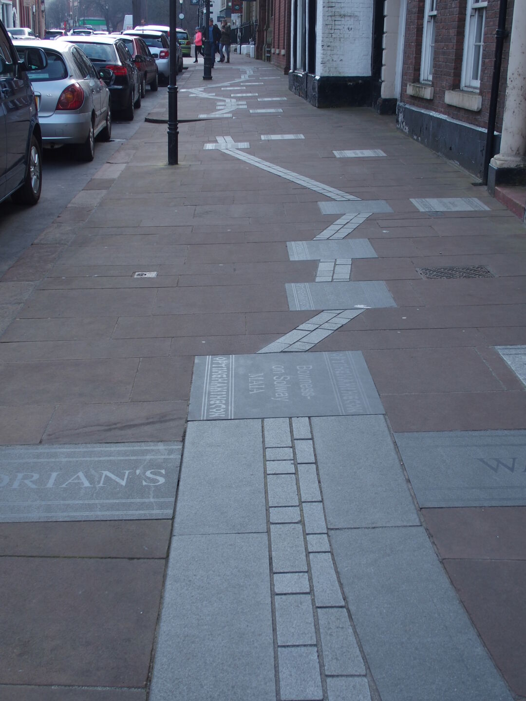 Hadrian&rsquo;s Wall Path embedded in the pavement in Carlisle.
