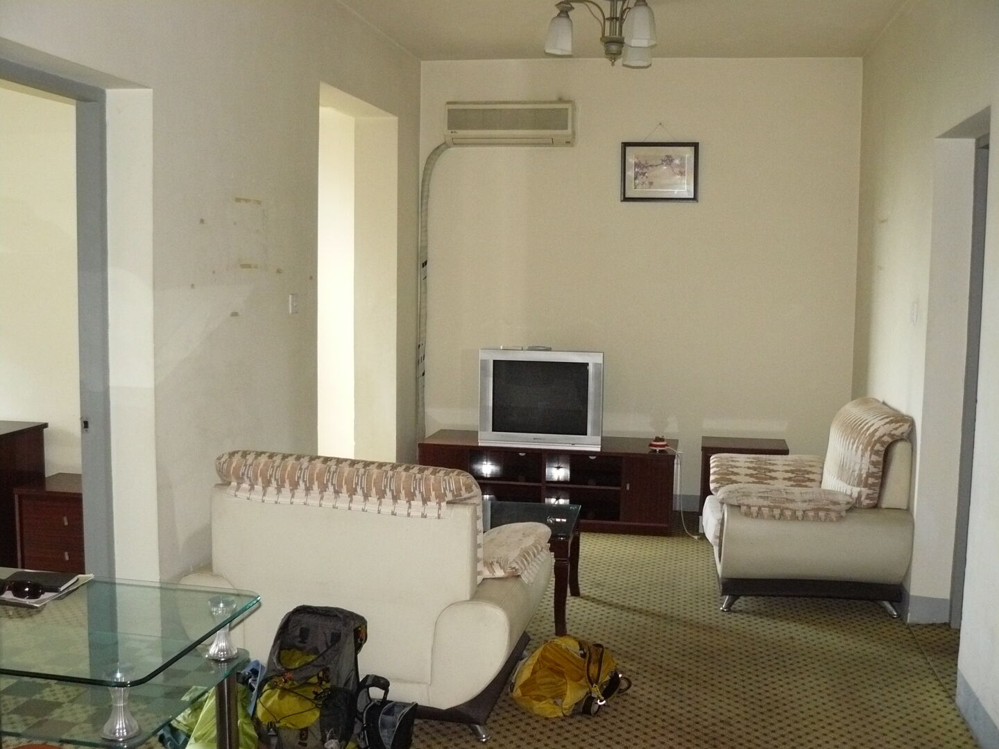 This is my living room, with the door to the bedroom on the right. The kitchen door is not visible, would be to the left. In my back is the entrance. The bright opening on the left in the back leads to the living room window.