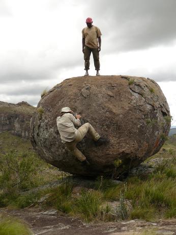 Adrien watches Frank climb up the boulder rock